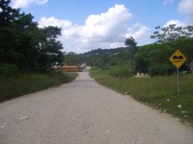 bump sign with bum on dirt road, Belize,  – Best Places In The World To Retire – International Living